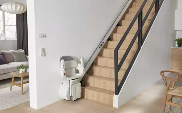 Access-HomeGlide-Compact Image shows an Access Stairlift at the bottom of the stairs