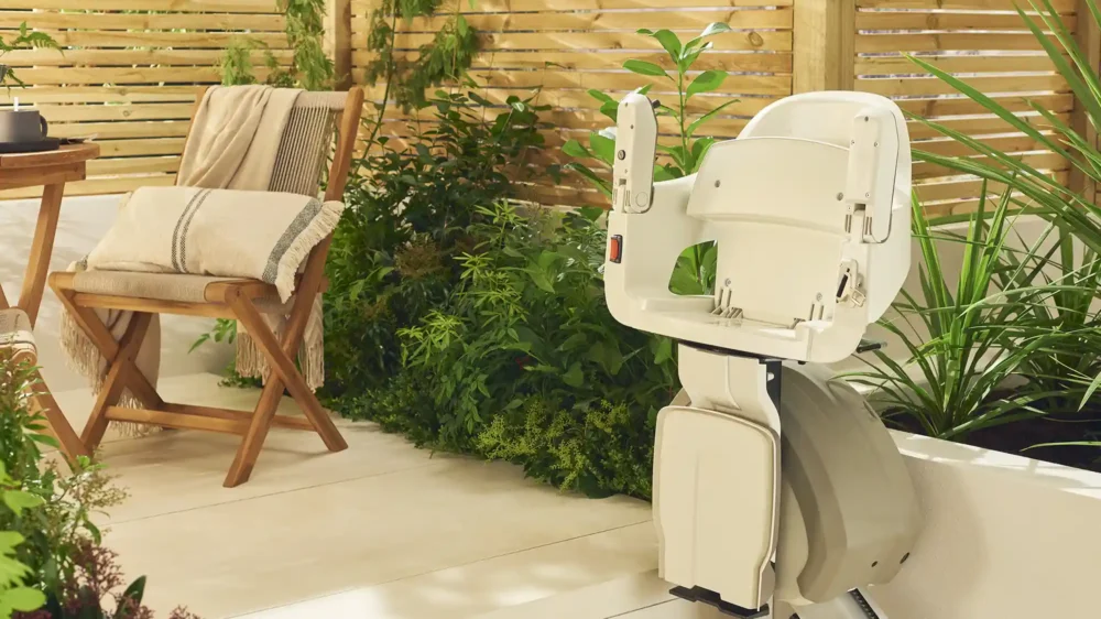Access-compact Image shows the Access HomeGlide Outdoor stairlift with armrests up and footrest up