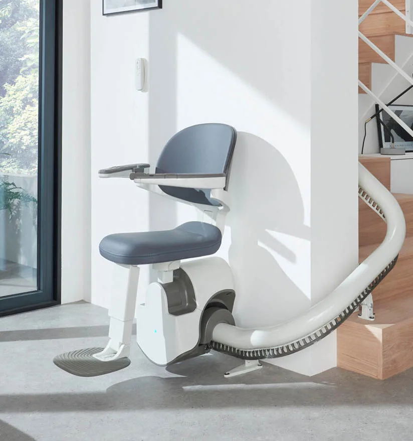Acess-Stairlift-Main Image shows one of the Access Stairlifts at the bottom of a curved staircase