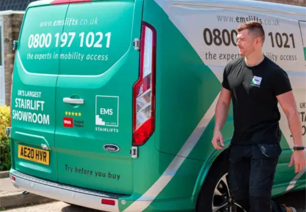 An EMS engineer next to an EMS van