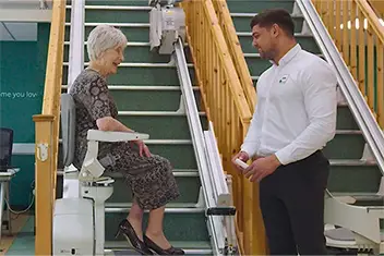 staiirlifts a happy customer trying out a stairlift in our showroom